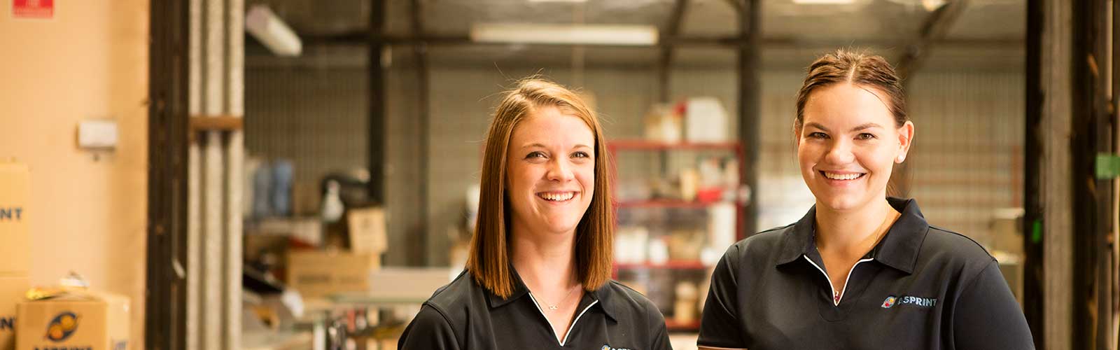 Two young women in a warehouse